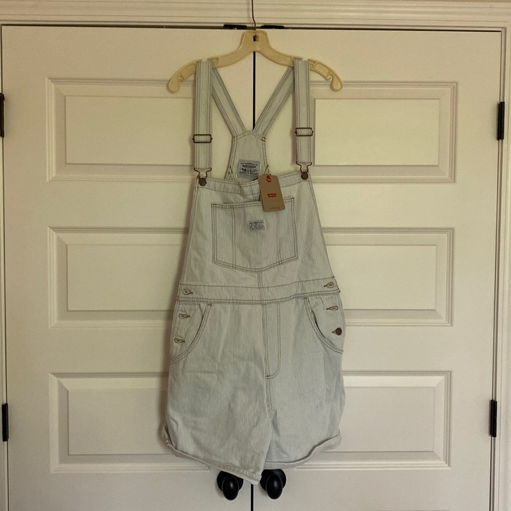 Never been worn with tags on pinstripe white background with light blue stripes.